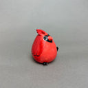 Ceramic sculpture of a very chubby red cardinal bird with black color accents and a hold in its head to act as a vase.