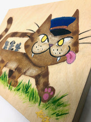 Painting on exposed wooden panel of a brown cat shaped like a bus, with a blue drivers cap and mice as passengers within. It walks atop grass.