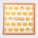 Handkerchief with orange border and repeating patterns of Catbus heads, with text that reads "My Neighbor Totoro" in the center in orange font.