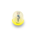 Small figurine inside a transparent dome with yellow base on a white background