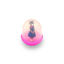 Small figurine of a cat in a dress inside a pink and white dome on a white background