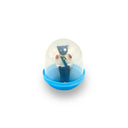 Small toy figure inside a transparent ball with a blue base on a white background