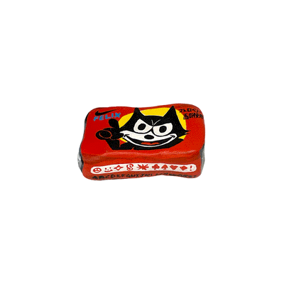 Small sculpture of a wrapped piece of square gum with a photo of Felix the Cat on it, looking happy but menacing.