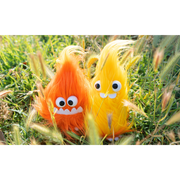2 plush fire sprites, one orange and one yellow, both with large plastic eyes and oversized teeth.