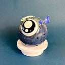 Ceramic sculpture of a small, blowfish with very very large eyes. It is blue with blue fins and green lips.