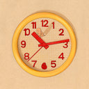 Illustration of a yellow rounded clock on a beige background. It has red numbers and hands, and a tiny character walks behind the hour hand and pushes it backwards.
