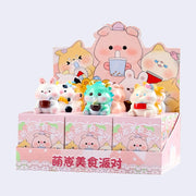 Blind boxed figures of assorted small, cute animals eating food or sipping drinks. Various ones sit atop their product packaging.