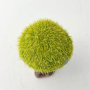 Ceramic tree with green grass flocking on the exterior of the tree top.