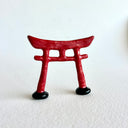 Small ceramic sculpture of a red Torii gate.