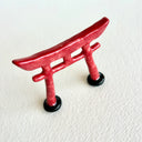 Small ceramic sculpture of a red Torii gate.