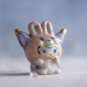 Small ceramic rabbit figurine with a blurred background