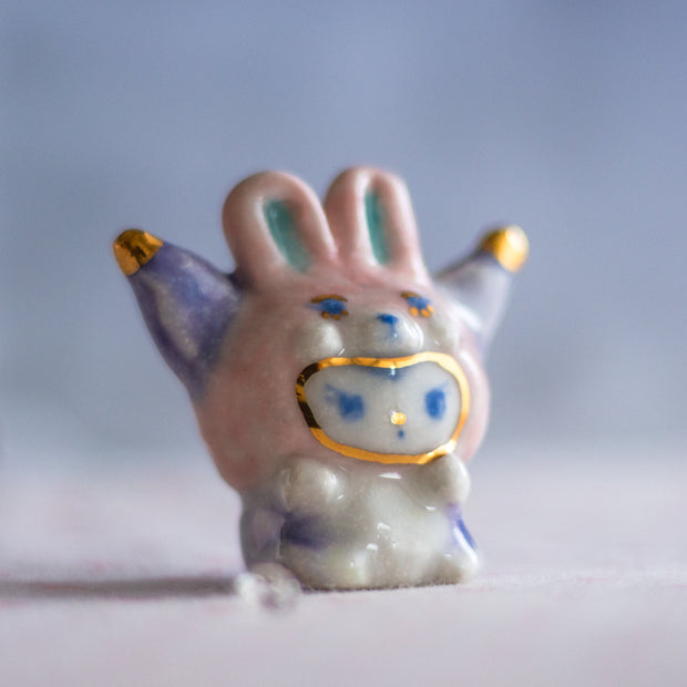 Small ceramic rabbit figurine with a blurred background