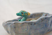 Ceramic dish with a blue dragon figurine on a white background