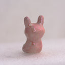 Pink rabbit figurine, back view.