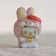 Ceramic rabbit figurine with gold accents on a light background