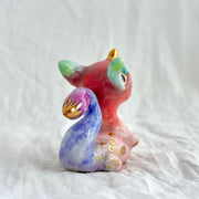 Colorful ceramic dragon figurine on a white background