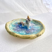 Small ceramic dish with a unicorn standing in the middle of it.