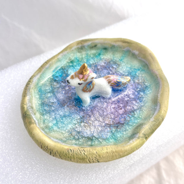 Small ceramic dish with a unicorn standing in the middle of it.