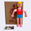 Soft vinyl figure of a tall office woman with short blonde hair, a bright pink vest and blue skirt.