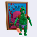 Green soft vinyl figurine of a nude, muscular Japanese man with scars all over his body. He holds a decapitated head in its hand.
