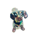 An iridescent dachshund-shaped sculpture with a metallic, rainbow-like finish on a plain white background.