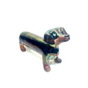 An iridescent dachshund-shaped sculpture with a metallic, rainbow-like finish on a plain white background.