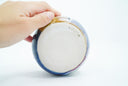 Underside of ceramic bowl with artist's stamp.