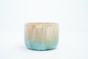 Small ceramic cup with a gradient of light brown to blue and gold speckles.