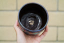 Inside view of ceramic mug, dark blue with gold artists stamp.