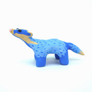 Sculpture of a blue badger, with cartoon coloring and features such as a very skinny neck, small head and large round black eyes.