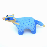 Sculpture of a blue badger, with cartoon coloring and features such as a very skinny neck, small head and large round black eyes.