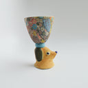 Ceramic floral cup with a brown floppy eared dog as a handle.