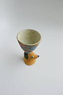 Ceramic floral cup with a brown floppy eared dog as a handle.