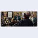 Four men in a room with a brick wall, two of whom are bald.