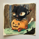 Illustration of a black cat riding in a jack o lantern car.
