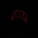 Wooden sculpture of a black dinosaur, flat mostly and emphasizing its silhouette.  Atop its back is a rounded plastic sheet with a line of lights, illuminating it and the interior of its mouth.