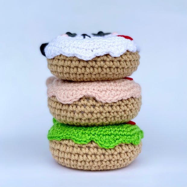 Stack of 3 crocheted donuts, with different colored frosting.