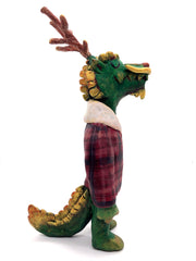 Sculpture of a green dragon with wooden antlers and yellow/gold color accents. It stands on 2 legs like a human and wears a red sherpa flannel jacket.