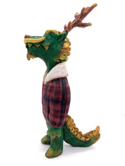 Sculpture of a green dragon with wooden antlers and yellow/gold color accents. It stands on 2 legs like a human and wears a red sherpa flannel jacket.