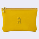 Yellow pouch with a small black illustration on a light gray background