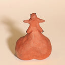 Ceramic sculpture of a tanuki - a raccoon creature - with a comically large ball sack, inflated to act as a base for him.