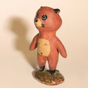 Small ceramic sculpture of a tanuki - a raccoon creature standing on a glazed ceramic platform.
