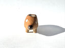 Ceramic sculpture of a brown dog made to look like a pencil, with a pointed tip black nose and a pink eraser shaped butt. It has several holes atop its back to hold pens.