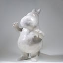 Ceramic sculpture of Moomin, posed like Frankenstein with its arms up and a line running across its head.
