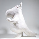 Ceramic sculpture of Moomin, posed like Frankenstein with its arms up and a line running across its head.