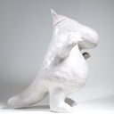 Ceramic sculpture of Moomin, posed like Frankenstein with its arms up and a line running across its head.