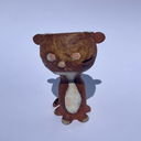Small ceramic animal figure of a cat or brown tiger or sorts, with a cup as its head.