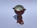 Small ceramic animal figure of a cat or brown tiger or sorts, with a cup as its head.
