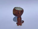 Small ceramic animal figure of a cat or brown tiger or sorts, with a cup as its head.