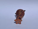 Small ceramic animal figure of a cat or brown tiger or sorts, with a cup as its head.